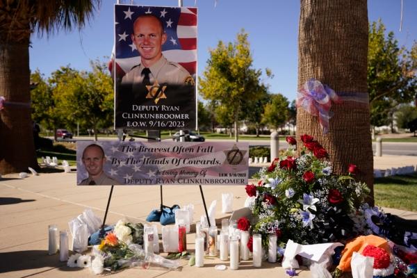 A shrine to honor deputy Ryan Clinkunbroomer is placed outside of the Palmdale Sheriff's Station during a press to announce an arrest in the ambush killing of the Los Angeles County sheriff's deputy, in Palmdale, Calif., on Sept. 18, 2023. (Marcio Jose Sanchez/AP Photo)