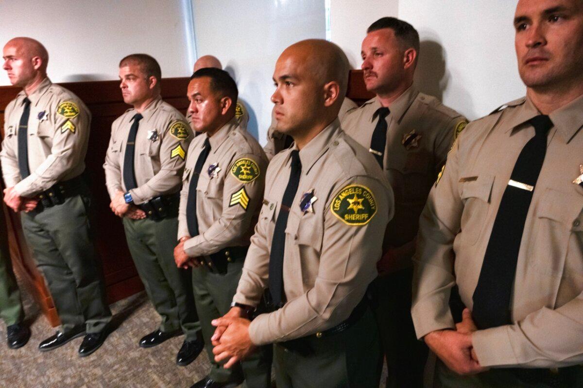 Los Angeles County Sheriff Deputies from Palmdale listen during a news conference as Los Angeles County District Attorney George Gascon announces charges in the killing of their colleague, sheriff's deputy Ryan Clinkunbroomer, at the Hall of Justice in downtown Los Angeles on Sept. 20, 2023. (Richard Vogel/AP Photo)