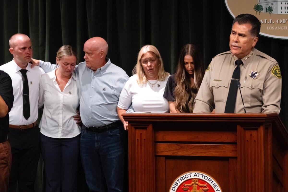 Los Angeles County Sheriff Robert Luna speaks as the family of sheriff's deputy Ryan Clinkunbroomer and his fiancée Brittany Lindsey (2nd R) stand during a news conference at the Hall of Justice in downtown Los Angeles on Sept. 20, 2023. (Richard Vogel/AP Photo)