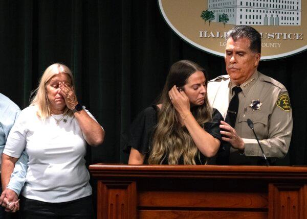 Los Angeles County Sheriff Robert Luna (R) comforts sheriff's deputy Ryan Clinkunbroomer's fiancee Brittany Lindsey as Clinkumbroomer's mother Kim wipes away tears during a news conference at the Hall of Justice in downtown Los Angeles on Sept. 20, 2023. (AP Photo/Richard Vogel)