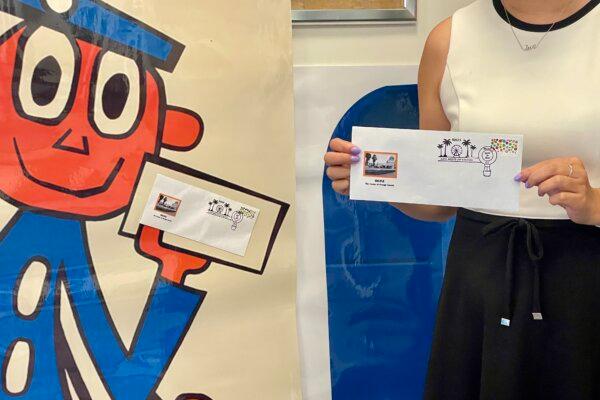 Irvine Post Master Lam Le displays a limited-edition postmark at Irvine Harvest Station Post Office in Irvine, Calif., on Sept. 26, 2023. (Carol Cassis/The Epoch Times)