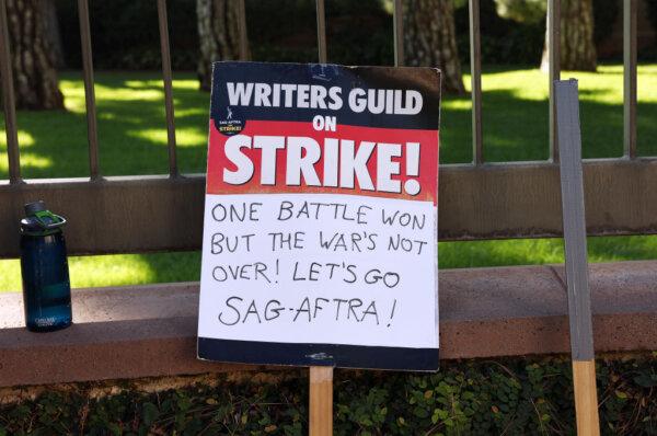 A Writers Guild of America support sign rests near SAG-AFTRA members picketing outside Warner Bros. Studio as the actors strike continues in Burbank, Calif., on Sept. 26, 2023. (Mario Tama/Getty Images)