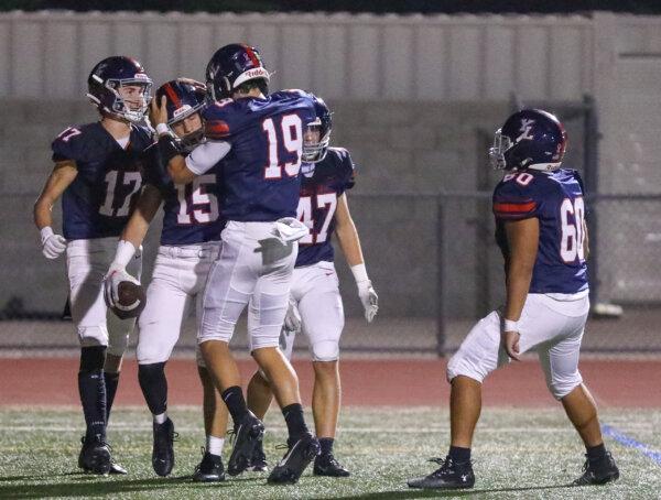 Yorba Linda High School varsity football players celebrate on the field on Oct. 13, 2023. (Courtesy of Emma Perron Photography)