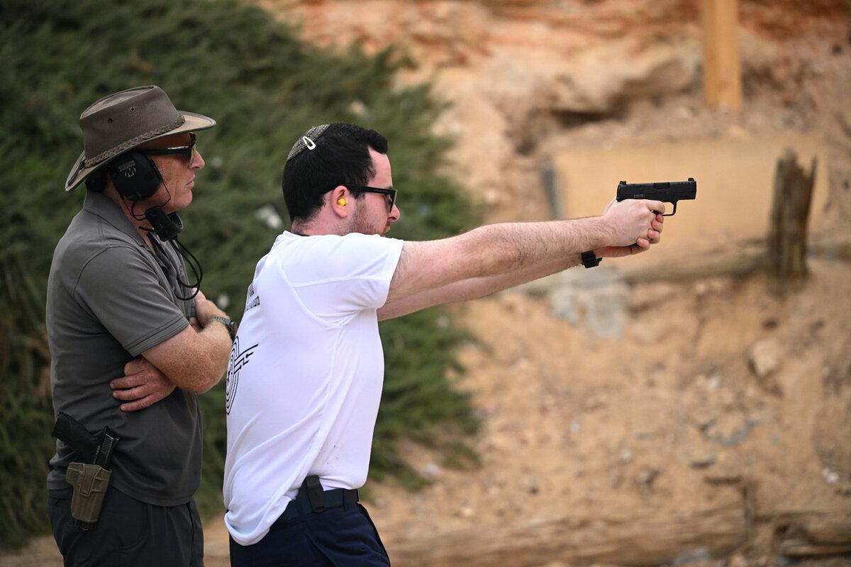 A member of the public receives weapons training from a tutor at a shooting range in Efrat, Israel, on Oct. 15, 2023. (Leon Neal/Getty Images)