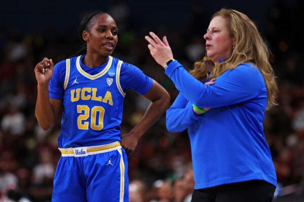 Charisma Osborne (20) of the UCLA Bruins talks with head coach Cori Close of the UCLA Bruins during the first half against the South Carolina Gamecocks in the Sweet 16 round of the NCAA Women's Basketball Tournament at Bon Secours Wellness Arena in Greenville, S.C., on March 25, 2023. (Maddie Meyer/Getty Images)