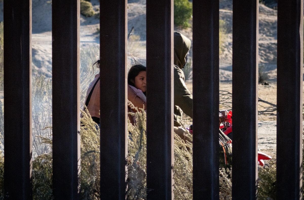 Human smugglers drive ATVs on the Mexican side of the United States border wall near Jacumba, Calif., on Oct. 31, 2023. (John Fredricks/The Epoch Times)