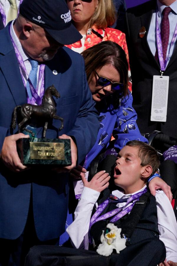 (R-L) Cody Dorman sits alongside his mother Leslie Dorman and father Kelly Dorman after jockey Junior Alvarado rode Cody's Wish to win the Breeders' Cup Dirt Mile horse race at Santa Anita Park in Arcadia, Calif., on Nov. 4, 2023. (Ashley Landis/AP Photo)