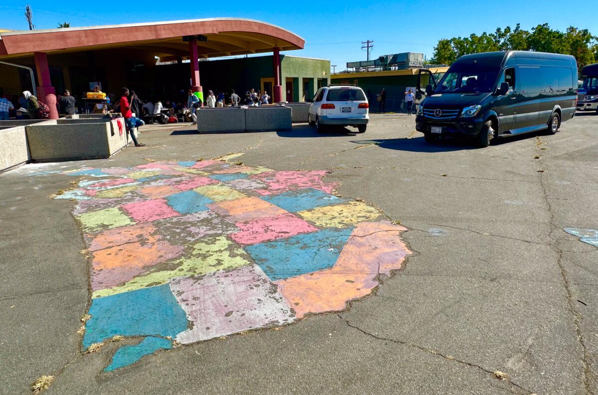 Migrants gather at a processing center run by San Diego nonprofit groups in the neighborhood of City Heights, Calif., on Oct. 31, 2023. (John Fredricks/The Epoch Times)