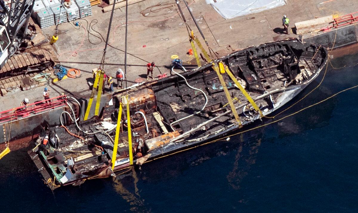 The burned hull of the dive boat Conception is brought to the surface by a salvage team off Santa Cruz Island, Calif., on Sept. 12, 2019. (Brian van der Brug/Los Angeles Times via AP)