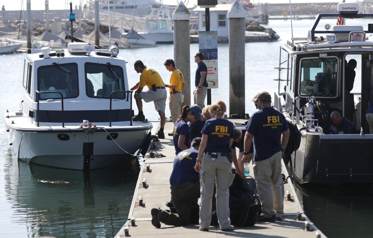 FBI personnel gather on a jetty by FBI Dive Team boats in Santa Barbara Harbor in Santa Barbara, Calif., on Sept. 4, 2019. (Mario Tama/Getty Images)