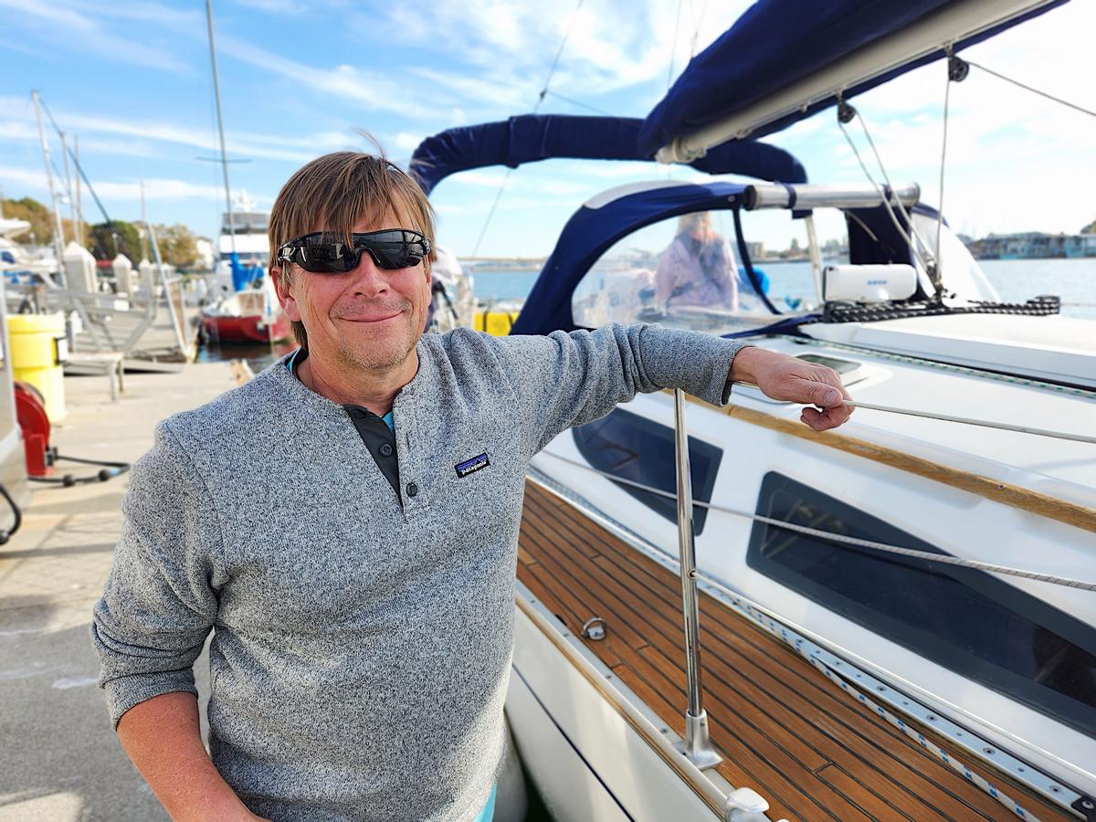 Simon Greaves of Sausalito, Calif., stands next to his sailboat anchored at Jack London Square in Oakland, Calif., on Nov. 10, 2023. (Allan Stein/The Epoch Times)