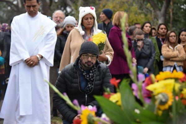 Members of the public pay their respects at an interfaith memorial service at the burial site of the ashes of 1,467 individuals who died but whose remains went unclaimed, at the Los Angeles County Crematory and Cemetery in Los Angeles on Dec. 5, 2018. (Robyn Beck/AFP via Getty Images)