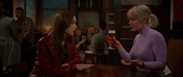 Alexandra (Phoebe Dynevor) and her sister Henrietta, a journalist (Naomi Battrick), in "Bank of Dave." (Ingenious Media/Netflix)