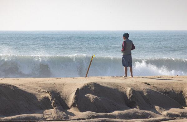Beachgoers and surfers enjoy high surf conditions in Newport Beach, Calif., on Dec. 28, 2023. (John Fredricks/The Epoch Times)
