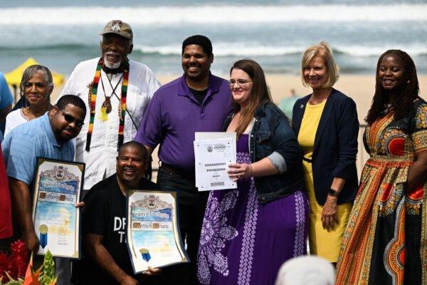 Members of the Bruce family stand with local officials and activists during a ceremony to return ownership of Bruce's Beach to the descendants of a Black family who had the land seized from them through eminent domain a century ago, in Manhattan Beach, Calif., on July 20, 2022. (Patrick T. Fallon/AFP via Getty Images)