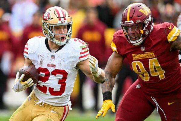 Christian McCaffrey (23) of the San Francisco 49ers runs with the ball during the second half of a game against the Washington Commanders at FedExField in Landover, Md., on Dec. 31, 2023. (Greg Fiume/Getty Images)