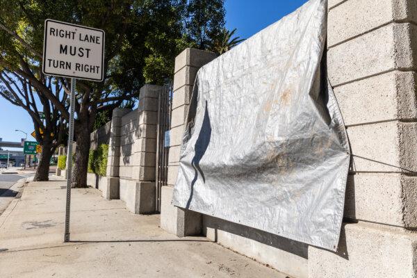 Graffiti left by pro-Palestinian protesters is covered by a tarp at the Los Angeles National Cemetery in Los Angeles on Jan. 8, 2024. (John Fredricks/The Epoch Times)