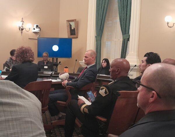 Assemblyman Kevin McCarty (D-Sacramento), author of AB 734 (C), seen with props including a water bottle and football used during opening remarks at a hearing in Sacramento, Calif., on Jan. 10, 2024. (Travis Gillmore/The Epoch Times)