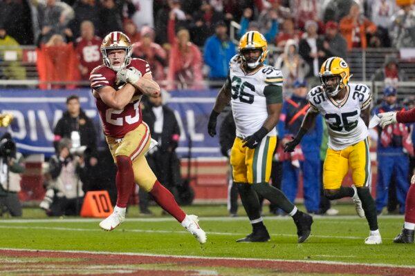 San Francisco 49ers running back Christian McCaffrey (23) scores a rushing touchdown during the second half of an NFL football NFC divisional playoff game against the Green Bay Packers in Santa Clara, Calif., on Jan. 20, 2024. (Godofredo A. Vásquez/AP Photo)