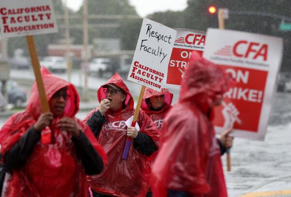 Members of the Cal State University (CSU) carry signs as they strike in front of San Francisco State University in San Francisco on Jan. 22, 2024. (Justin Sullivan/Getty Images)