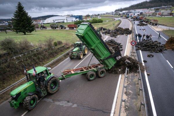 A farmer dumps waste on a road near Vesoul, France, on Jan. 25, 2024. (Sebastien Bozon/AFP)