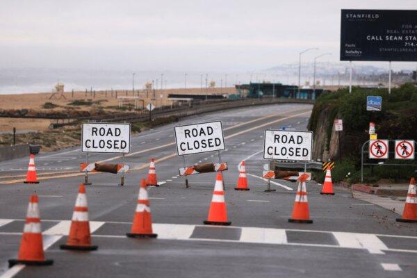 A section of the Pacific Coastal Highway is closed from flooding during a rain storm in Bolsa Chica, near Huntington Beach, Calif., on Feb. 1, 2024. (David Swanson/AFP)