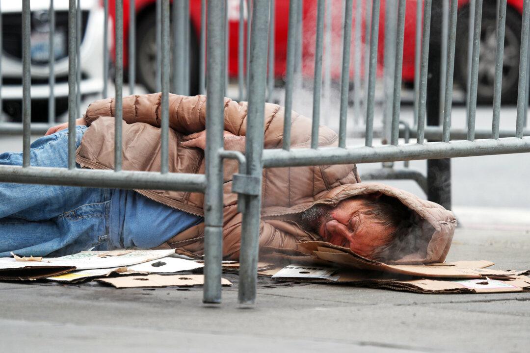 A homeless man sleeps on the sidewalk in San Francisco on Dec. 5, 2019. (Justin Sullivan/Getty Images)