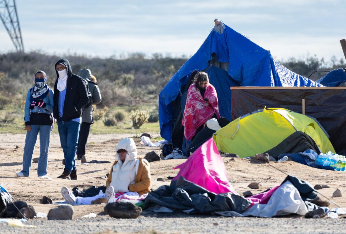 Illegal immigrants station themselves at an encampment after crossing the United States border in Jacumba, Calif., on Feb. 3, 2024. (John Fredricks/The Epoch Times)