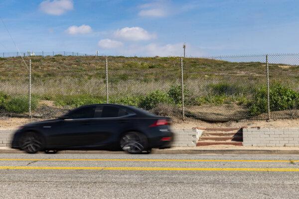 A car drives past a set of stairs that once led to a home in the abandoned Surfridge neighborhood in Playa Del Rey on Feb. 14, 2024. (John Fredricks/The Epoch Times)