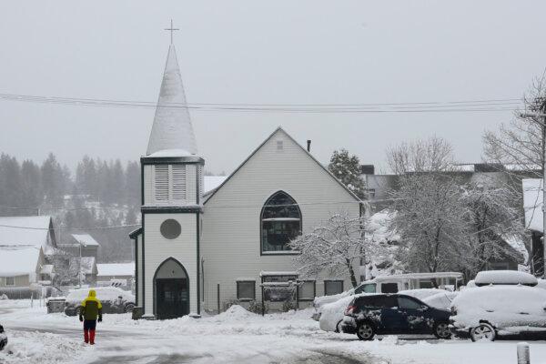 A person walks along a covered Jibboom Street in Truckee, Calif., on March 1, 2024. (Andy Barron/AP Photo)