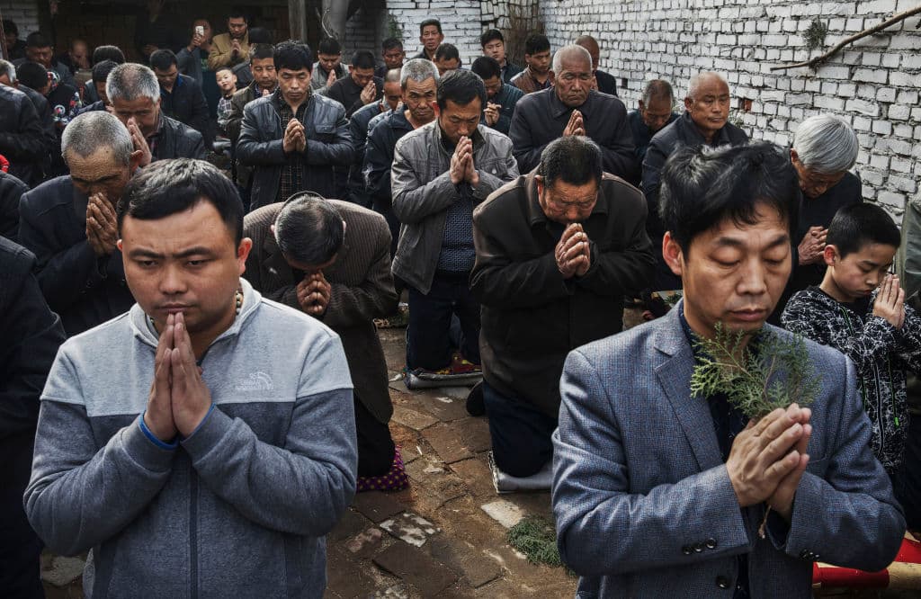 Chinese Catholic worshippers kneel and pray during Palm Sunday Mass during the Easter Holy Week at an "underground" or "unofficial" church near Shijiazhuang, Hebei Province, on April 9, 2017. (Kevin Frayer/Getty Images)