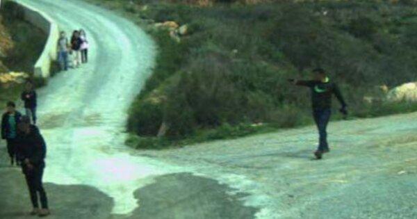 Bandits at the U.S.-Mexico border who allegedly were waiting for a group of illegal immigrants to cross and then pointed a gun at them, on Feb. 25, 2024. The groups are becoming more emboldened lately, according to the National Border Patrol Council. (Courtesy of the U.S. Border Patrol)