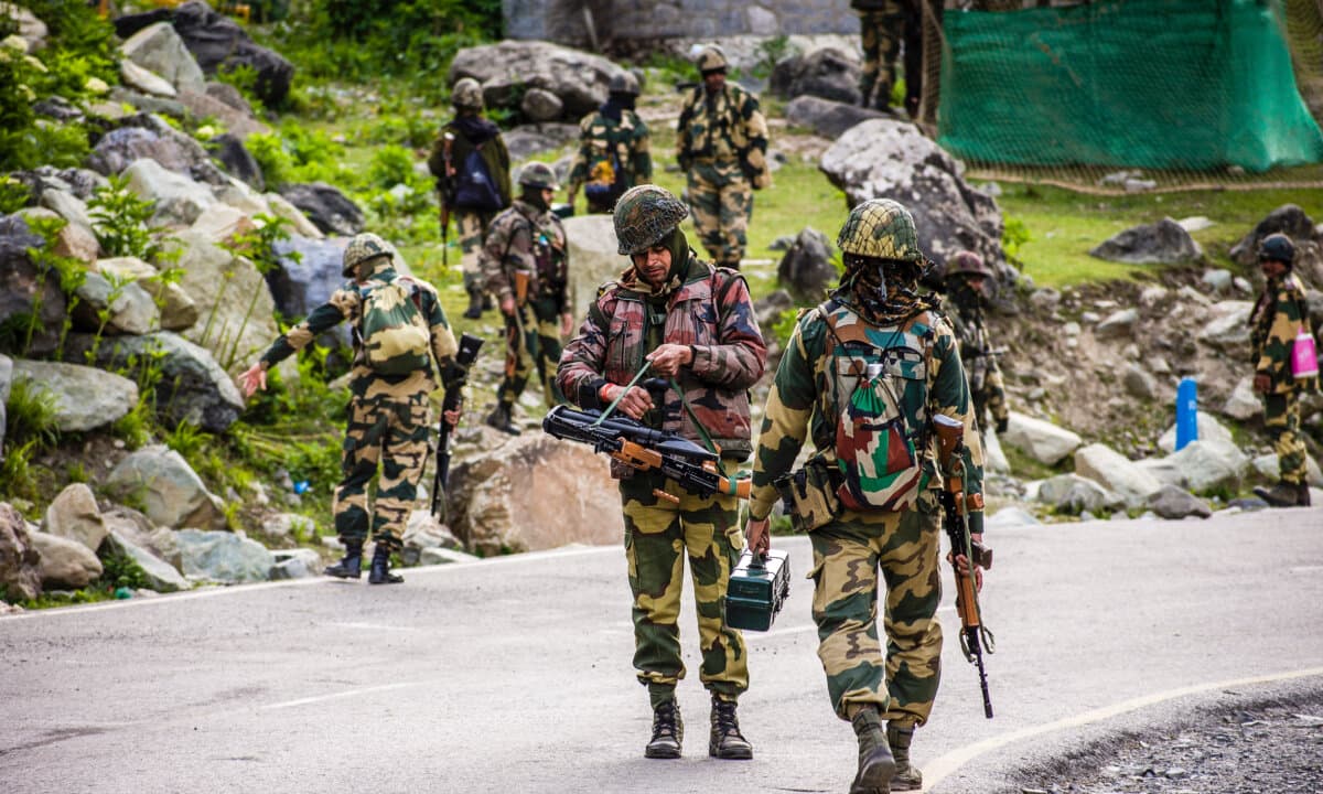 Indian Border Security Force soldiers patrol as an Indian army convoy passes through on a highway leading toward Leh, bordering China, in Gagangir, India, on June 19, 2020. (Yawar Nazir/Getty Images)
