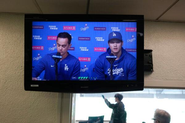 A video screen displays Los Angeles Dodgers' Shohei Ohtani (R) and interpreter Will Ireton during a news conference at Dodger Stadium in Los Angeles on March 25, 2024. (Jae C. Hong/AP Photo)