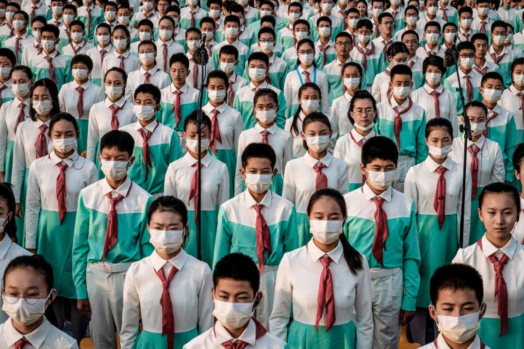 Chinese choir members stand together at a ceremony marking the 100th anniversary of the Chinese Communist Party at Tiananmen Square in Beijing on July 1, 2021. (Kevin Frayer/Getty Images)