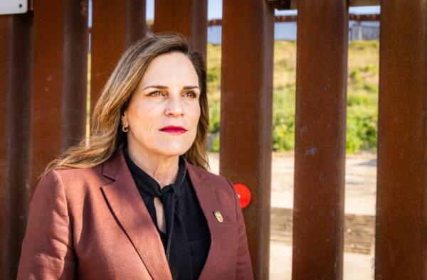 Amy Reichert, founder of Restore San Diego, stands near the United States border wall in San Diego, Calif., on April 11, 2024 (John Fredricks/The Epoch Times)