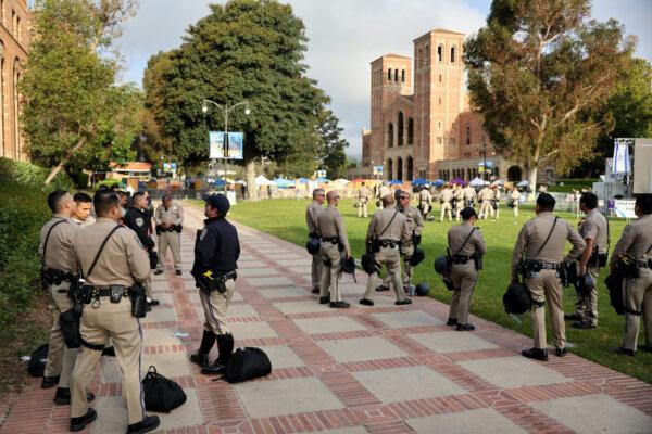 California Highway Patrol (CHP) officers keep watch at a pro-Palestinian encampment the morning after it was attacked by counter-protestors at the University of California, Los Angeles (UCLA) campus in Los Angeles, Calif., on May 1, 2024. (Mario Tama/Getty Images)