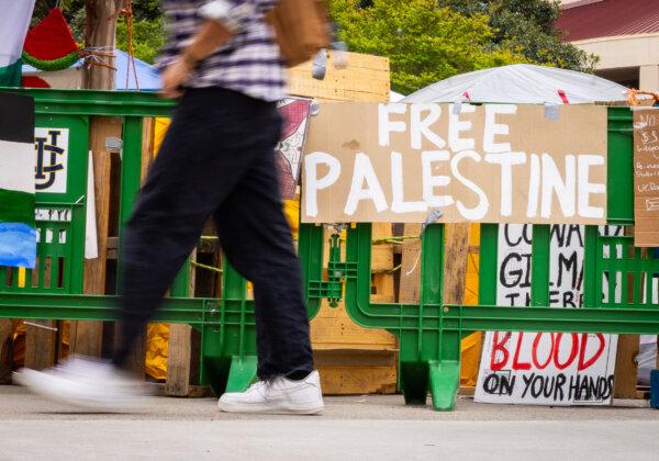 A pro-Palestinian sign on a barricade at the University of California–Irvine on May 2, 2024. (John Fredricks/The Epoch Times)