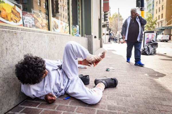 JJ Smith checks on the well-being of homeless people in the Tenderloin District of San Francisco on May 16, 2024. (John Fredricks/The Epoch Times)