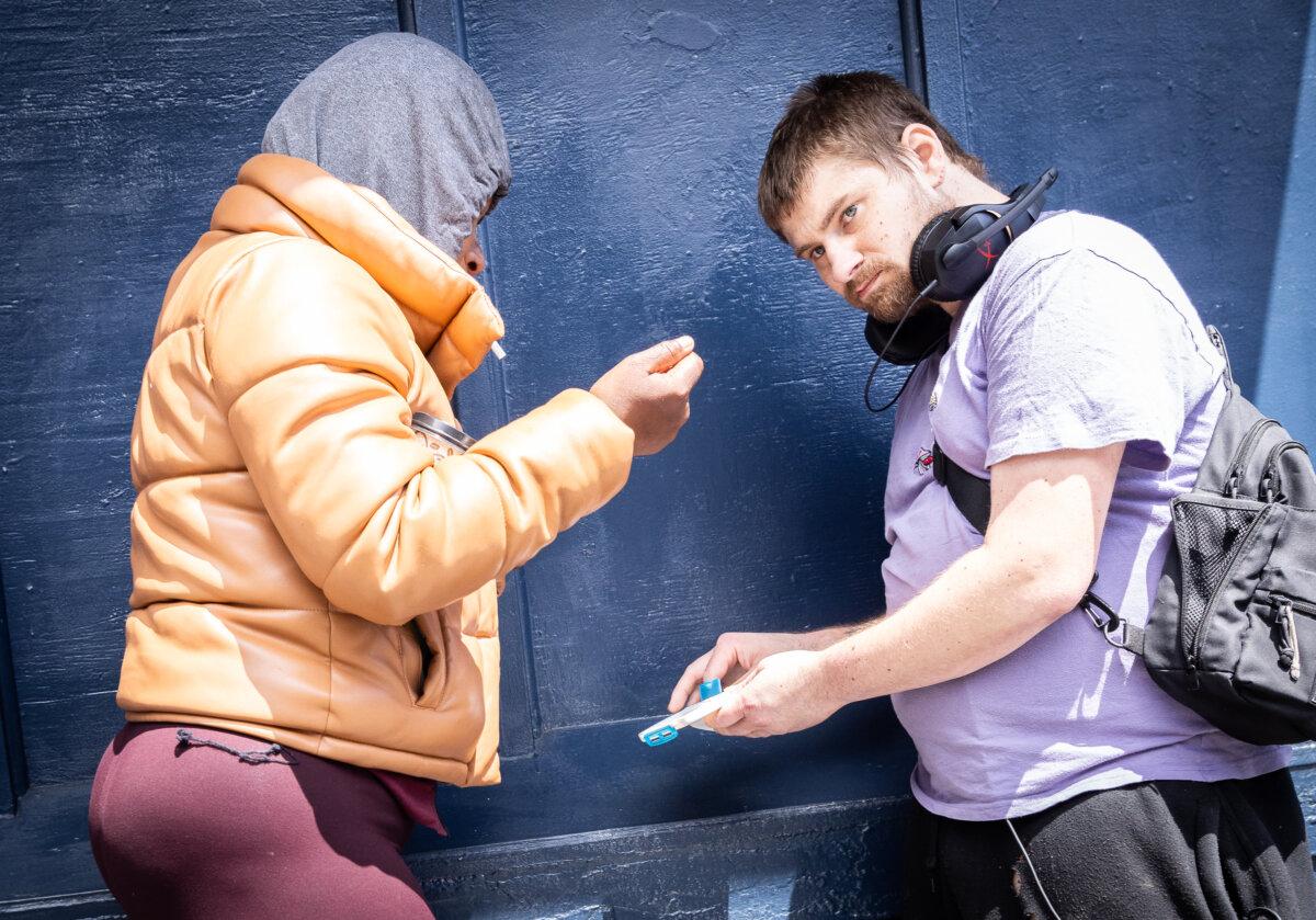 People hold drugs in the Tenderloin district of San Francisco on May 16, 2024. (John Fredricks/The Epoch Times)
