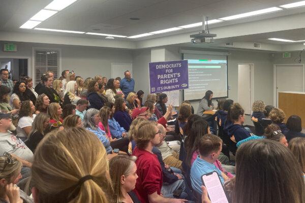 The crowd packed the boardroom, and a similar number were outside following a live stream. (Sophia Fang/The Epoch Times)