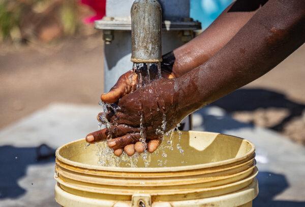 A water well built by Water Wells for Africa donated by actor Charlie Sheen continues operation in Southern Malawi on June 30, 2021. (John Fredricks/The Epoch Times)