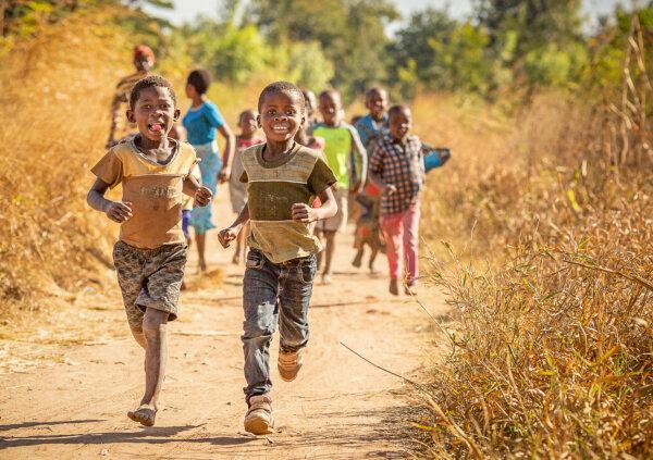 Children run to a water well built by Water Wells for Africa in Southern Malawi on June 14, 2019. (John Fredricks/The Epoch Times)