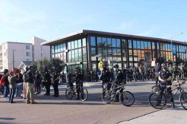 Police separate the Patriot March participants from counterprotesters in Pacific Beach, San Diego, on Jan. 9, 2021. (Tina Deng/The Epoch Times)
