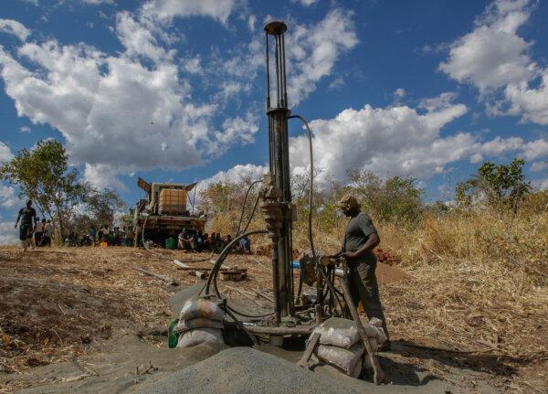 Contracted drillers work with Water Wells for Africa in building water wells in rural Malawi, Africa, on June 15, 2017. (John Fredricks/The Epoch Times)
