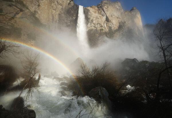 Water flows forcefully down Bridalveil Fall in Yosemite Valley, with rainbows visible in the mist, as warming temperatures have increased snowpack runoff, in Yosemite National Park, Calif., on April 27, 2023. (Mario Tama/Getty Images)