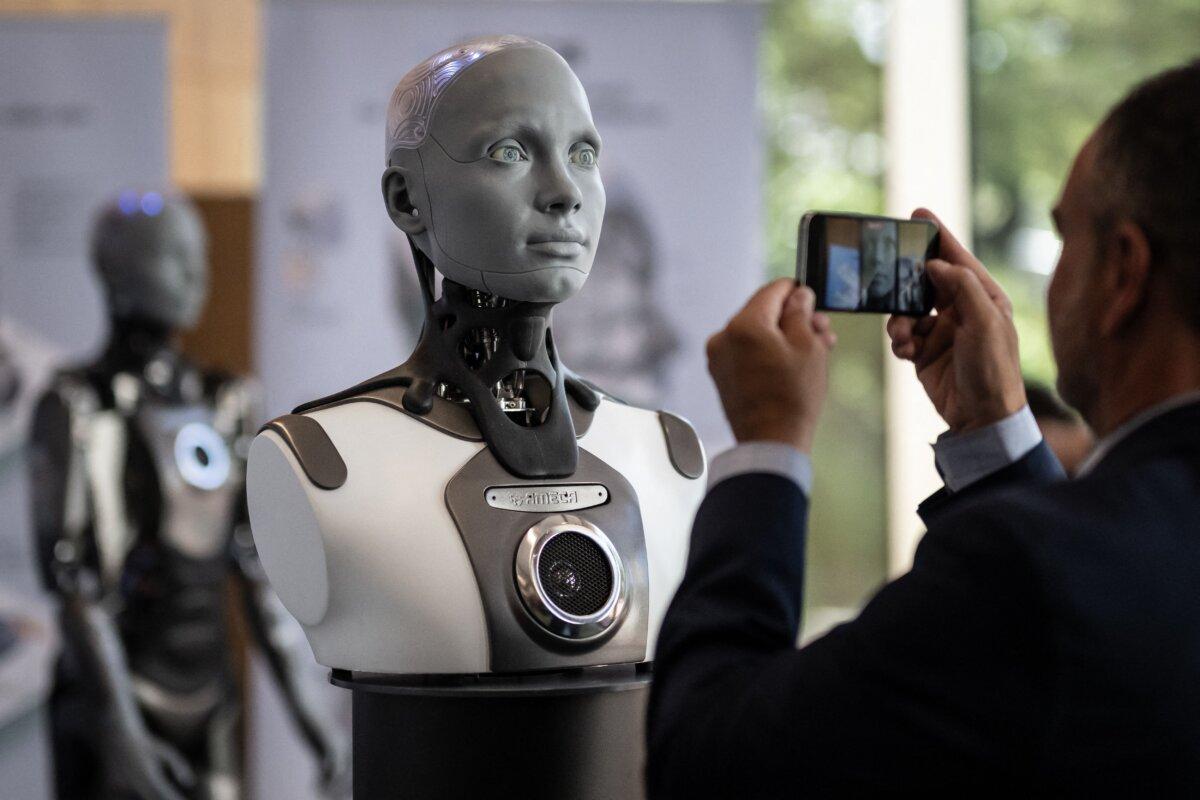 A visitor takes a picture of humanoid AI robot "Ameca" at the International Telecommunication Union AI for Good Global Summit in Geneva on July 5, 2023. (Fabrice Coferini/AFP via Getty Images)