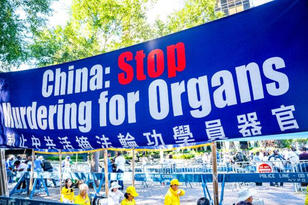 A banner calling for the end of forced organ harvesting from Falun Gong practitioners in China is displayed as practitioners demonstrate the spiritual practice's meditation, next to the United Nations in New York City on Sept. 20, 2023. (Chung I Ho/The Epoch Times)