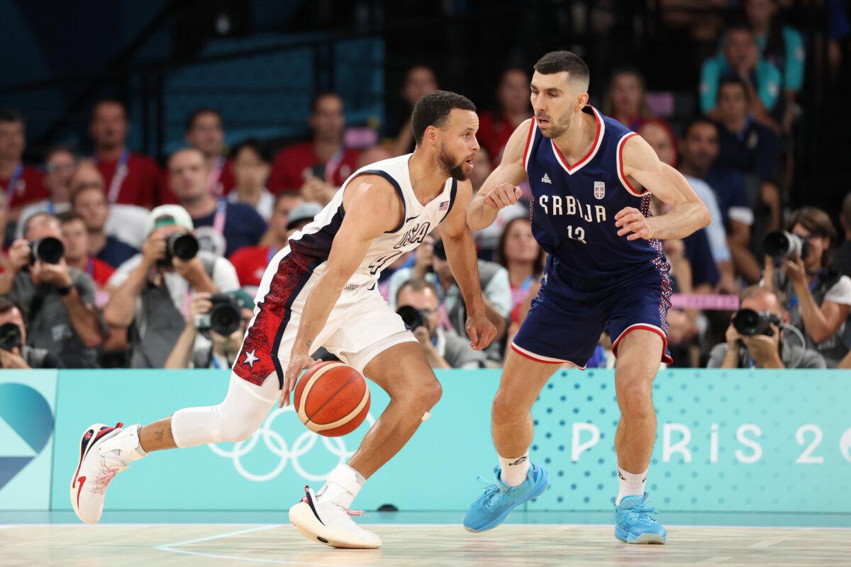 Stephen Curry of Team USA drives past Serbia's Ognjen Dobric during a men's basketball semifinal contest at the Olympics in Paris on Aug. 8, 2024. (Ezra Shaw/Getty Images)