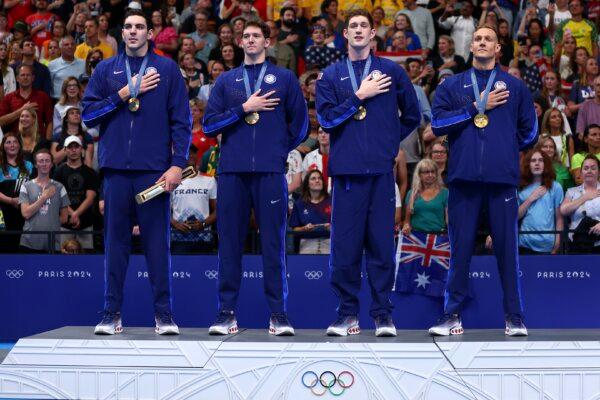 Gold Medalists, Jack Alexy, Chris Guiliano, Hunter Armstrong and Caeleb Dressel of Team United States stand for the national anthem with their medals during the Medal Ceremony after the Men's 4x100m Freestyle Relay Final on day one of the Olympic Games Paris 2024 in Nanterre, France, on July 27, 2024. (Maddie Meyer/Getty Images)